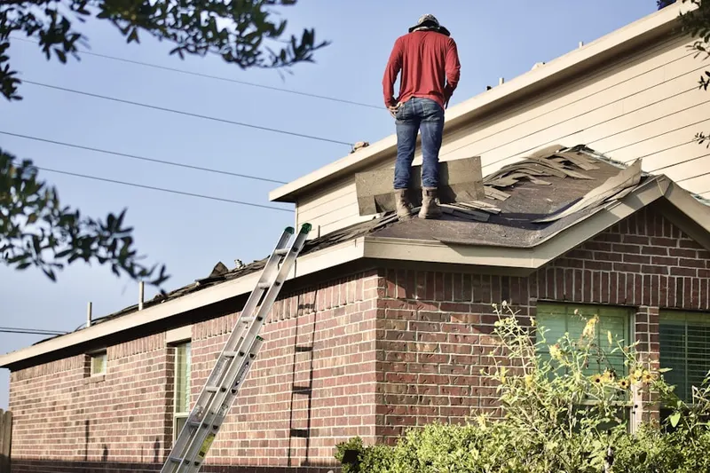 Professional roofer working on a residential roof in Rowlett